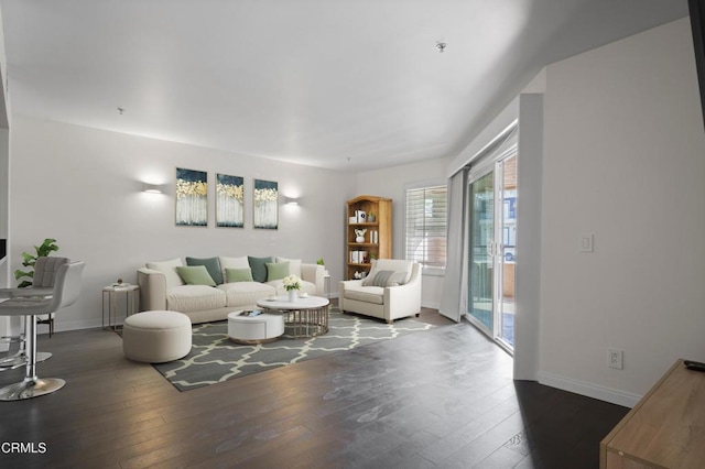 living room with baseboards and hardwood / wood-style flooring