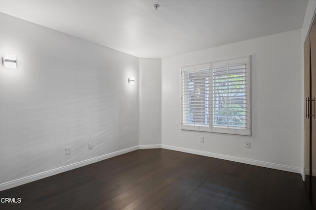 1200 Pacific Coast Hwy Unit 108, Huntington Beach, CA 92648 - unfurnished room with baseboards and dark wood finished floors