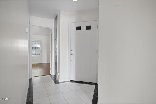 1200 Pacific Coast Hwy Unit 108, Huntington Beach, CA 92648 - foyer with light tile patterned flooring and baseboards