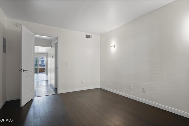 1200 Pacific Coast Hwy Unit 108, Huntington Beach, CA 92648 - empty room featuring dark wood-type flooring, baseboards, and visible vents