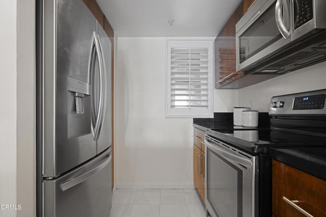 1200 Pacific Coast Hwy Unit 108, Huntington Beach, CA 92648 - kitchen with stainless steel appliances and baseboards