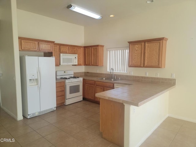 kitchen with white appliances, kitchen peninsula, light tile patterned floors, and sink