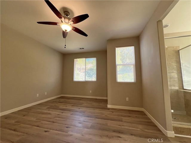 empty room featuring ceiling fan and hardwood / wood-style flooring