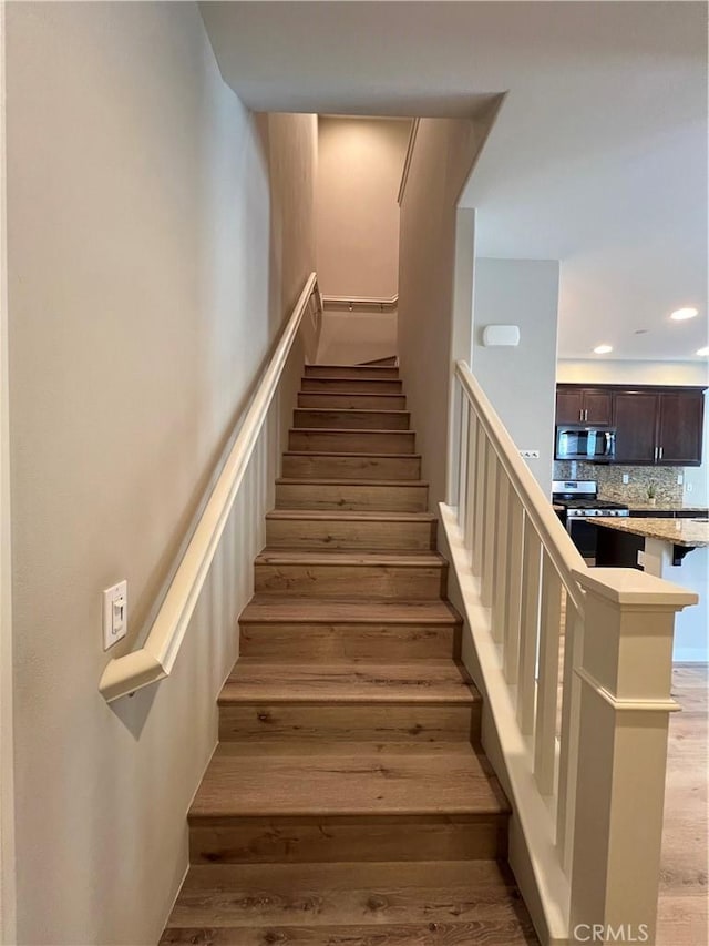 stairs with hardwood / wood-style floors