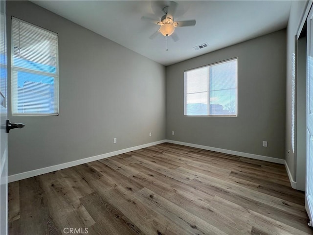 unfurnished room with ceiling fan and light wood-type flooring