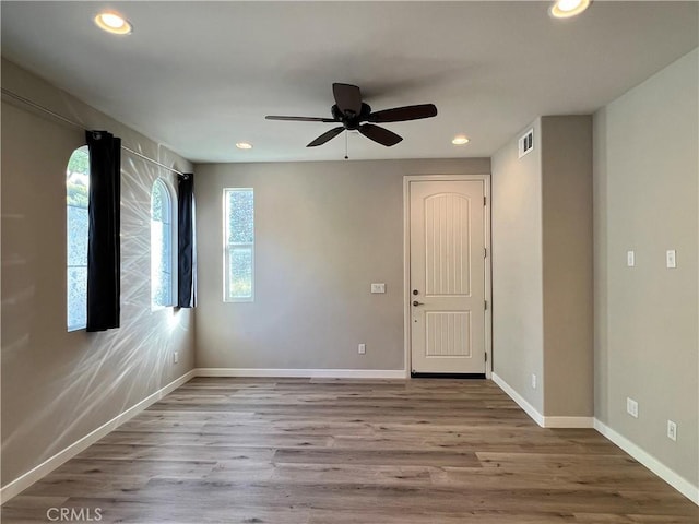 spare room with ceiling fan and light hardwood / wood-style floors