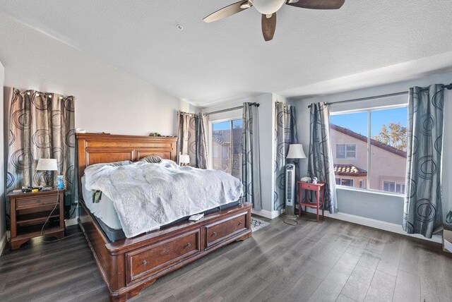 bedroom featuring a textured ceiling, ceiling fan, and dark hardwood / wood-style floors