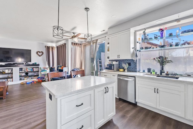 kitchen featuring white cabinets, a center island, decorative light fixtures, stainless steel appliances, and ceiling fan