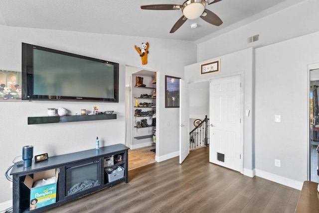 living room with vaulted ceiling, ceiling fan, and wood-type flooring