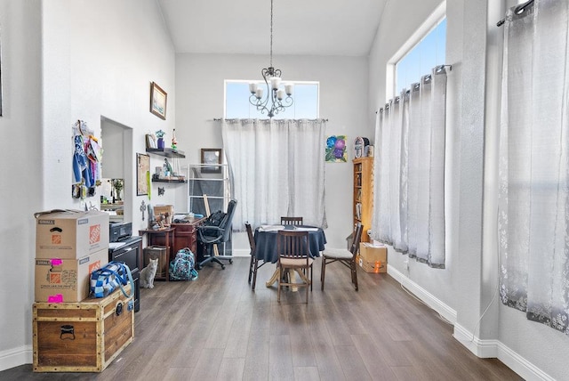 interior space featuring wood-type flooring and a notable chandelier