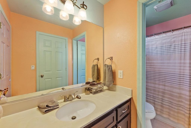 bathroom featuring tile patterned floors, toilet, and vanity