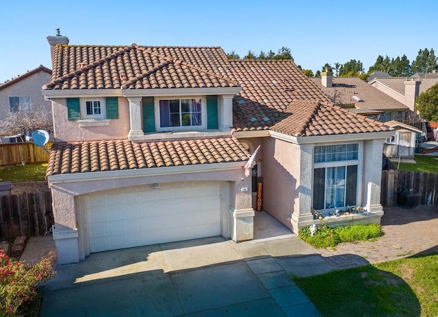 mediterranean / spanish-style home with a garage