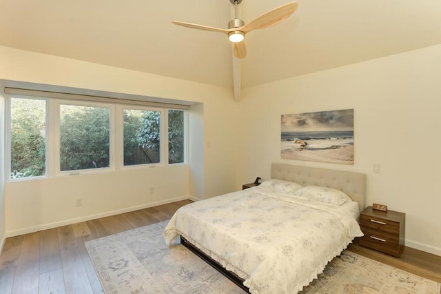 bedroom featuring vaulted ceiling, ceiling fan, and light wood-type flooring