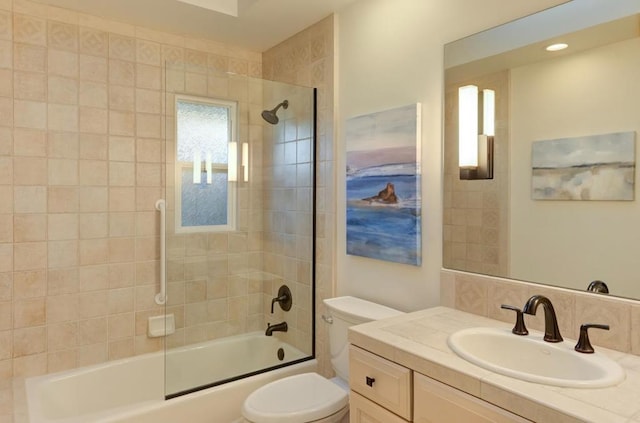 full bathroom with toilet, vanity, and bath / shower combo with glass door