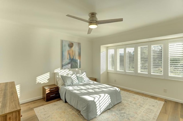 bedroom with ceiling fan and light wood-type flooring