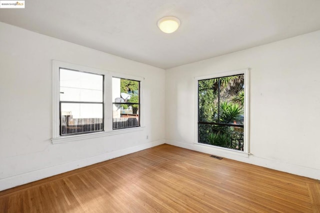 spare room featuring hardwood / wood-style floors