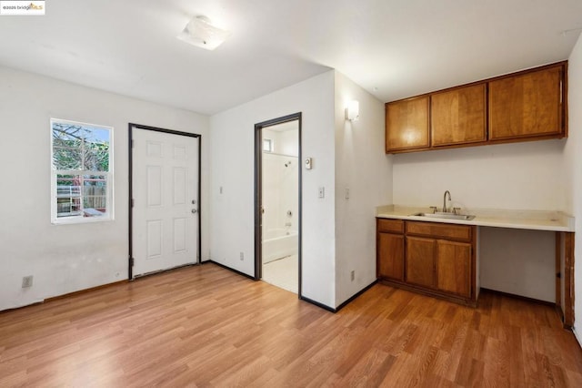 kitchen featuring light wood-type flooring and sink