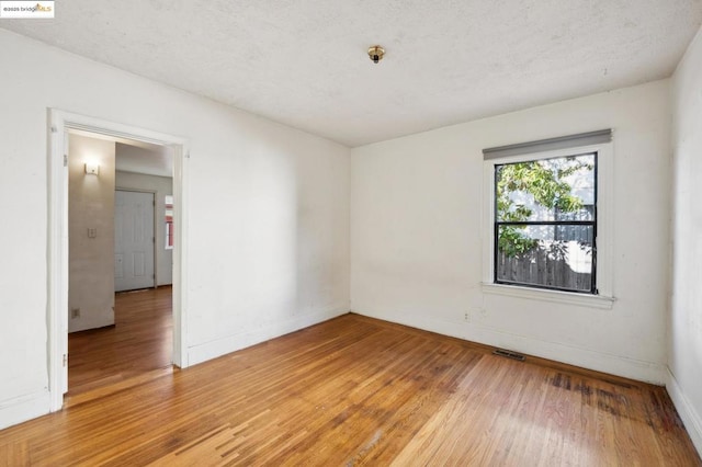 empty room with hardwood / wood-style floors