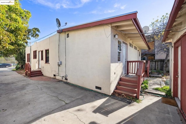 view of side of property featuring a patio area