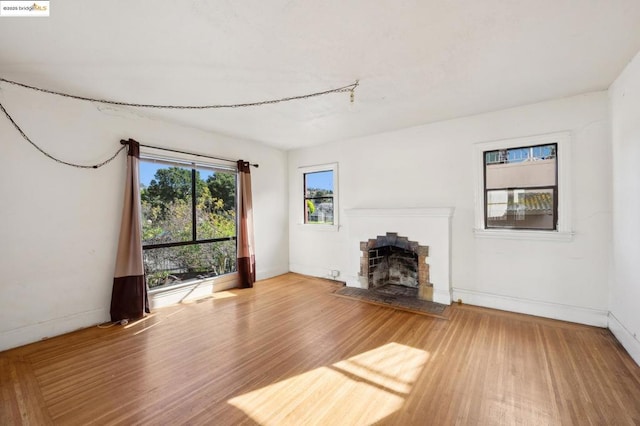 unfurnished living room with hardwood / wood-style flooring