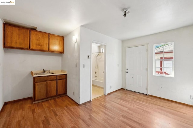 kitchen with light hardwood / wood-style flooring and sink