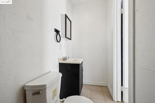 bathroom featuring toilet, tile patterned flooring, and vanity