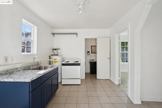 kitchen featuring a wealth of natural light, white electric range oven, blue cabinetry, and sink