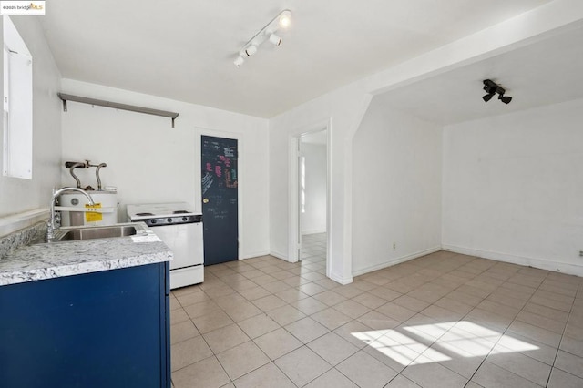 kitchen with blue cabinets, light tile patterned flooring, white electric stove, and sink