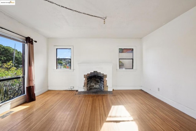 unfurnished living room with a fireplace and hardwood / wood-style floors