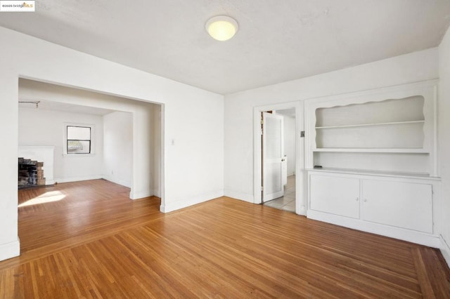 unfurnished living room with wood-type flooring