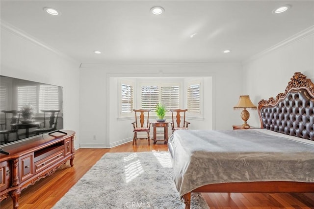 bedroom with ornamental molding and light hardwood / wood-style flooring