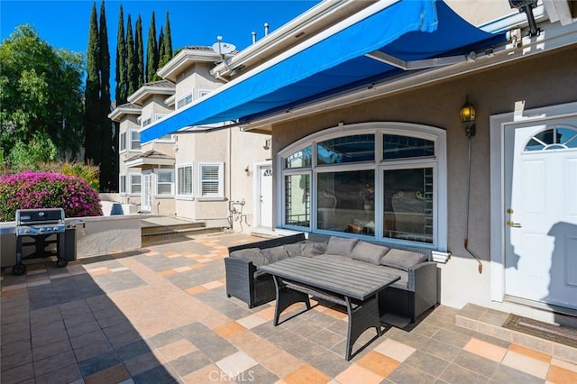 view of patio with area for grilling and an outdoor hangout area