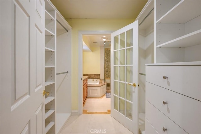 spacious closet featuring light tile patterned floors