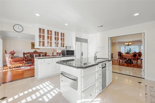 kitchen featuring sink, light tile patterned flooring, and white cabinetry