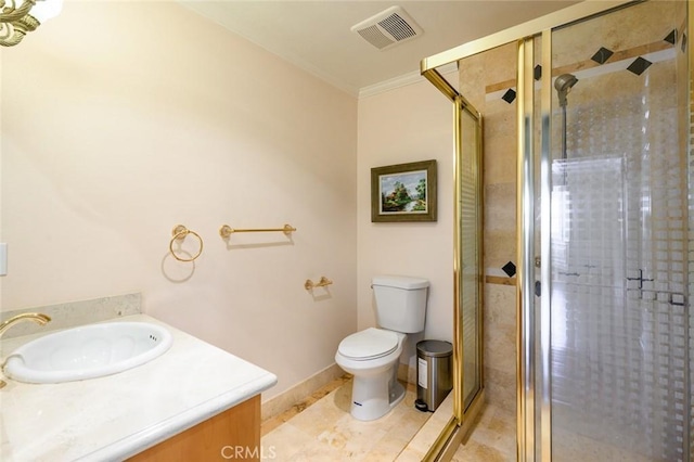 bathroom with ornamental molding, a shower with door, vanity, and toilet