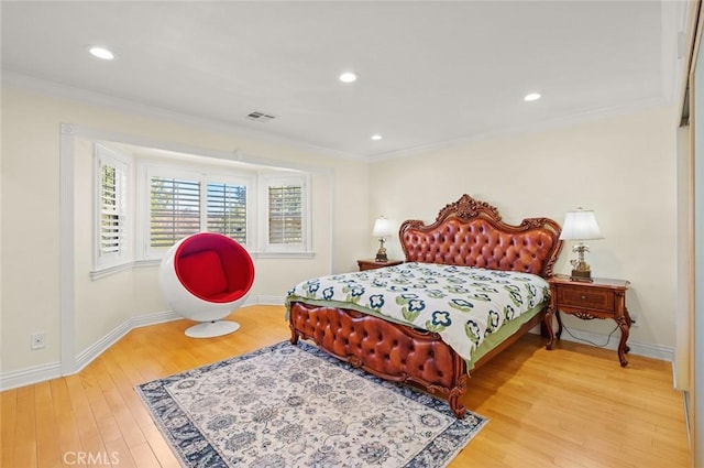 bedroom featuring crown molding and hardwood / wood-style flooring