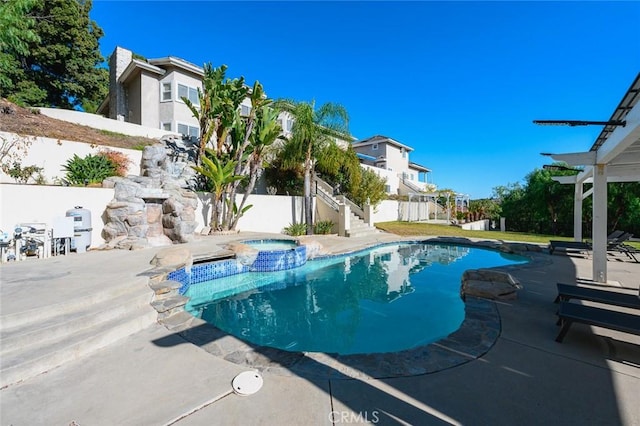 view of pool with an in ground hot tub and a patio