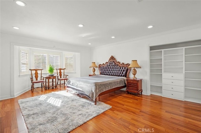 bedroom featuring hardwood / wood-style floors and ornamental molding