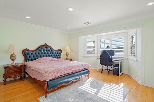 bedroom with hardwood / wood-style floors and crown molding