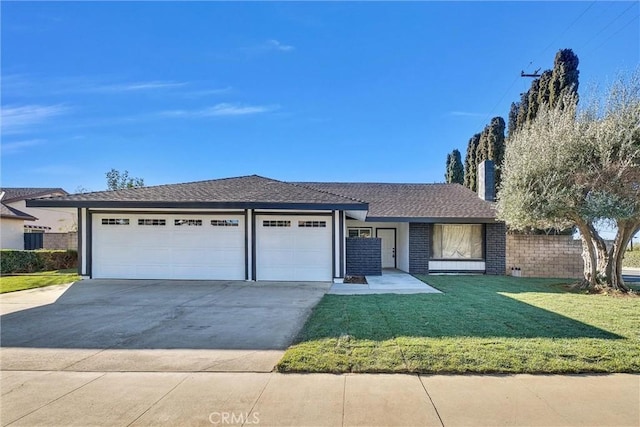 view of front of property with a garage and a front lawn