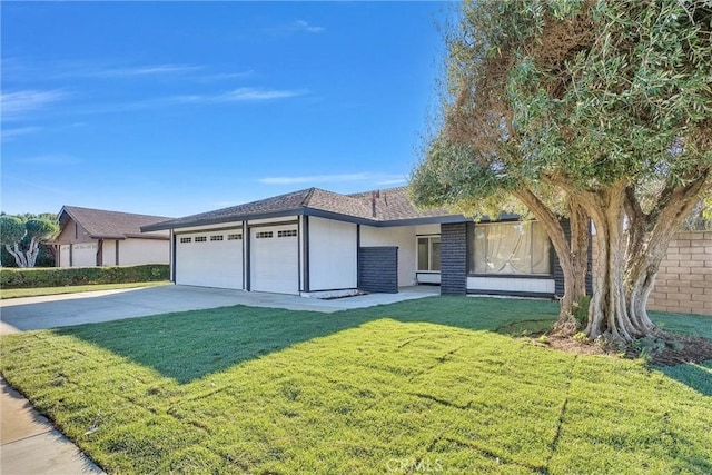 view of front of house with a front yard and a garage