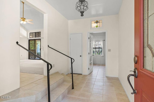 tiled foyer entrance with ceiling fan