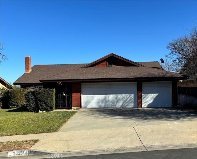 ranch-style home featuring a front lawn and a garage