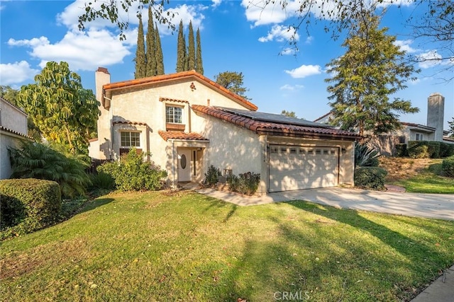 mediterranean / spanish-style house featuring solar panels, a front yard, and a garage