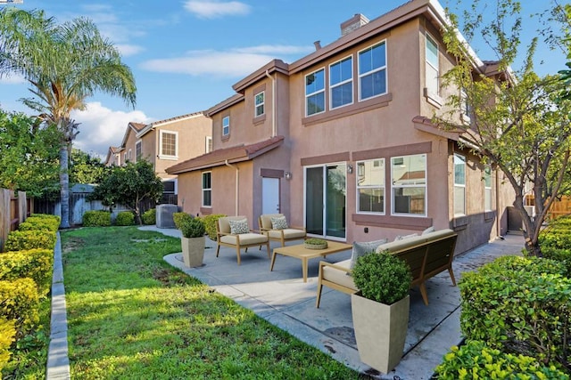 rear view of property with a patio, a yard, central AC, and an outdoor living space