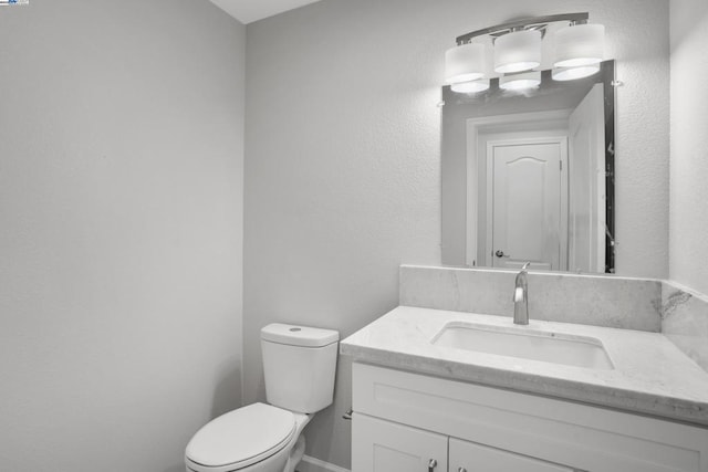 bathroom featuring toilet and vanity