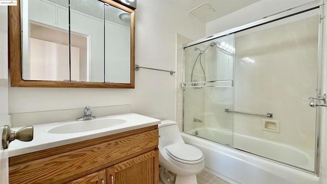 full bathroom featuring toilet, vanity, and bath / shower combo with glass door