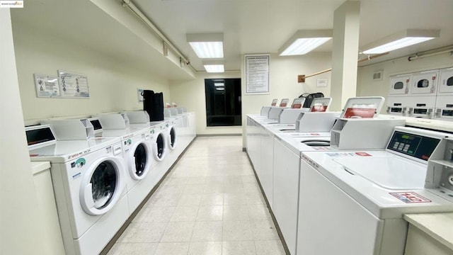 washroom featuring washing machine and clothes dryer