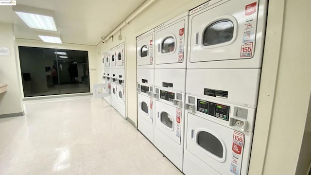 washroom featuring stacked washer and dryer and washing machine and dryer