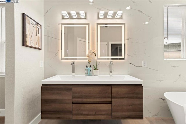 bathroom featuring a bath and vanity